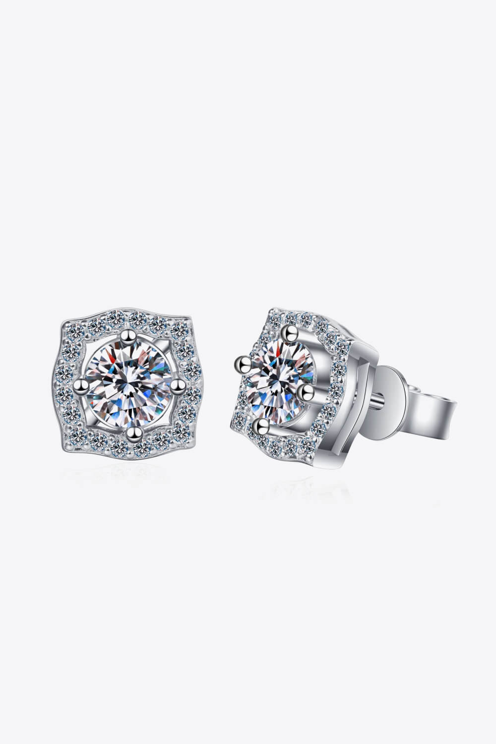 Scalloped halo moissanite stud earrings in silver with a central round-cut stone surrounded by smaller stones.