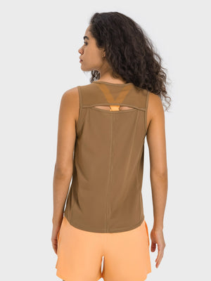 Camel mesh-back performance tank top with cutout detail and orange accent strap.