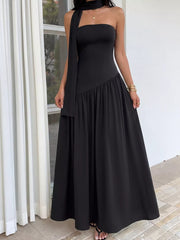Black strapless maxi dress with asymmetrical tiered skirt and matching scarf detail.
