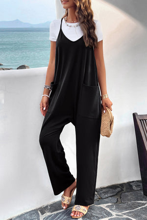 Black relaxed drape pocket jumpsuit with V-neck and wide legs, layered over a white tee.