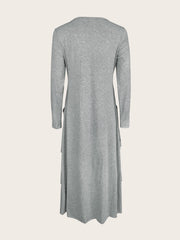 Light gray long sleeve midi dress with asymmetrical tiered hem and pockets.