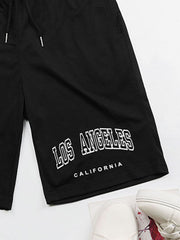 Black jogger shorts with "Los Angeles California" graphic print and drawstring waist.