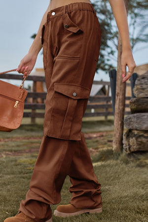 Brown utility cargo pants with wide legs and snap-button pockets.