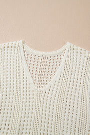 Beige open-knit mini dress with V-neck and drawstring waist detail.