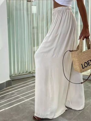 Apricot maternity pants with paperbag waist and wide legs.