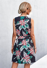 Black floral mini dress with tie waist and zip front, sleeveless.