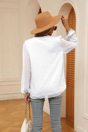 White Swiss dot blouse with poet sleeves and ruffled cuffs, shown from the back.