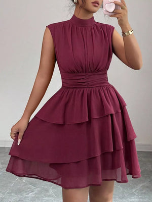 Dark Red sleeveless ruffled tiered mini dress with mock neck and cinched waist.