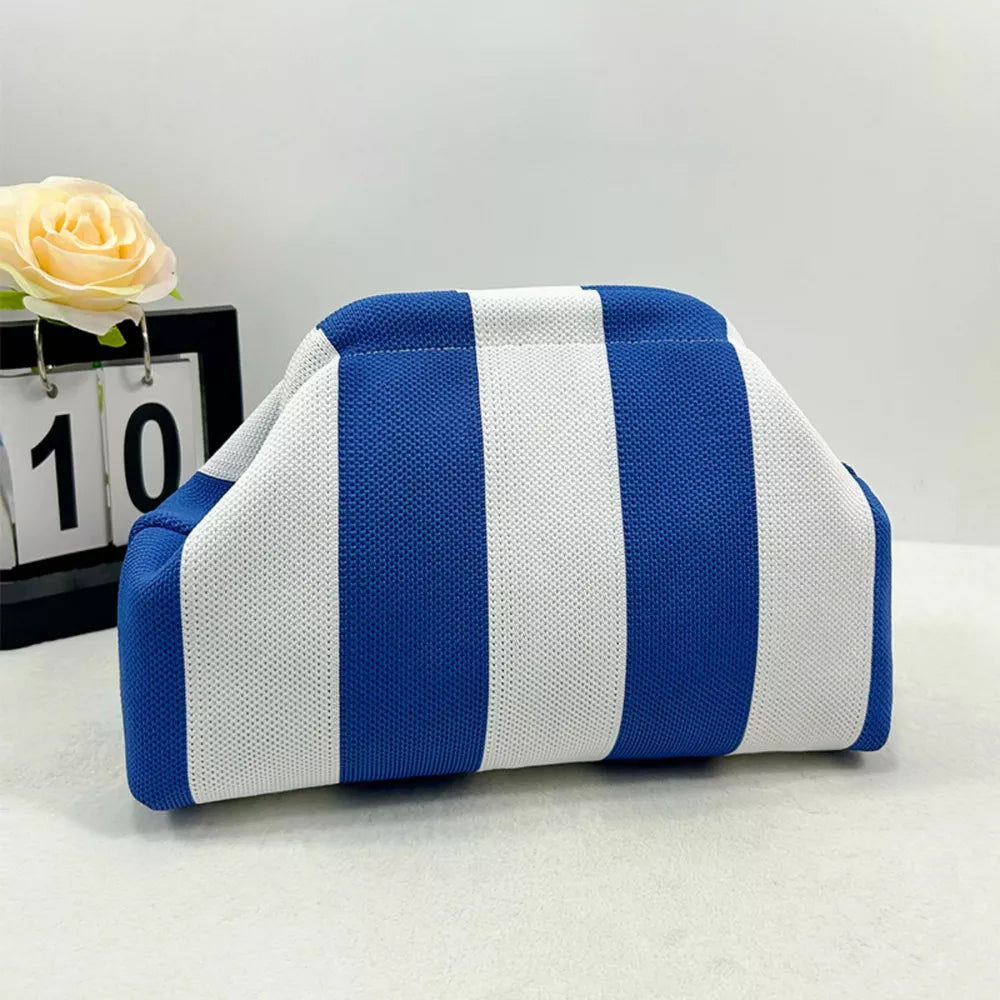 Vibrant knit clutch with striking blue and white stripes.