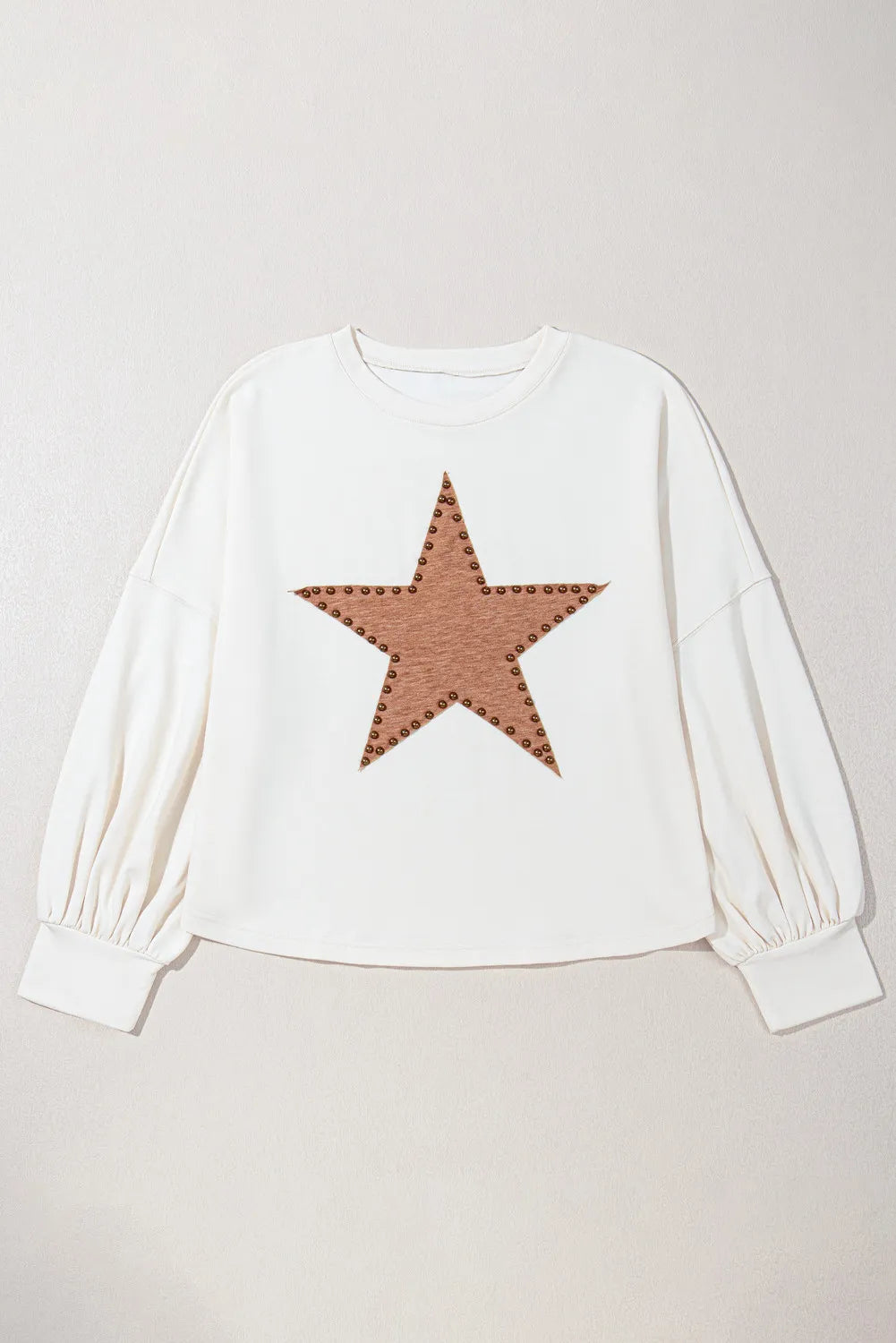 White sweatshirt with studded star detail and balloon sleeves