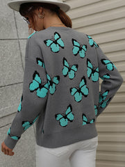 Gray knit crewneck sweater with allover turquoise butterfly motif.