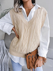 Cream openwork cable knit vest with V-neck and diamond pattern, styled over a white shirt.