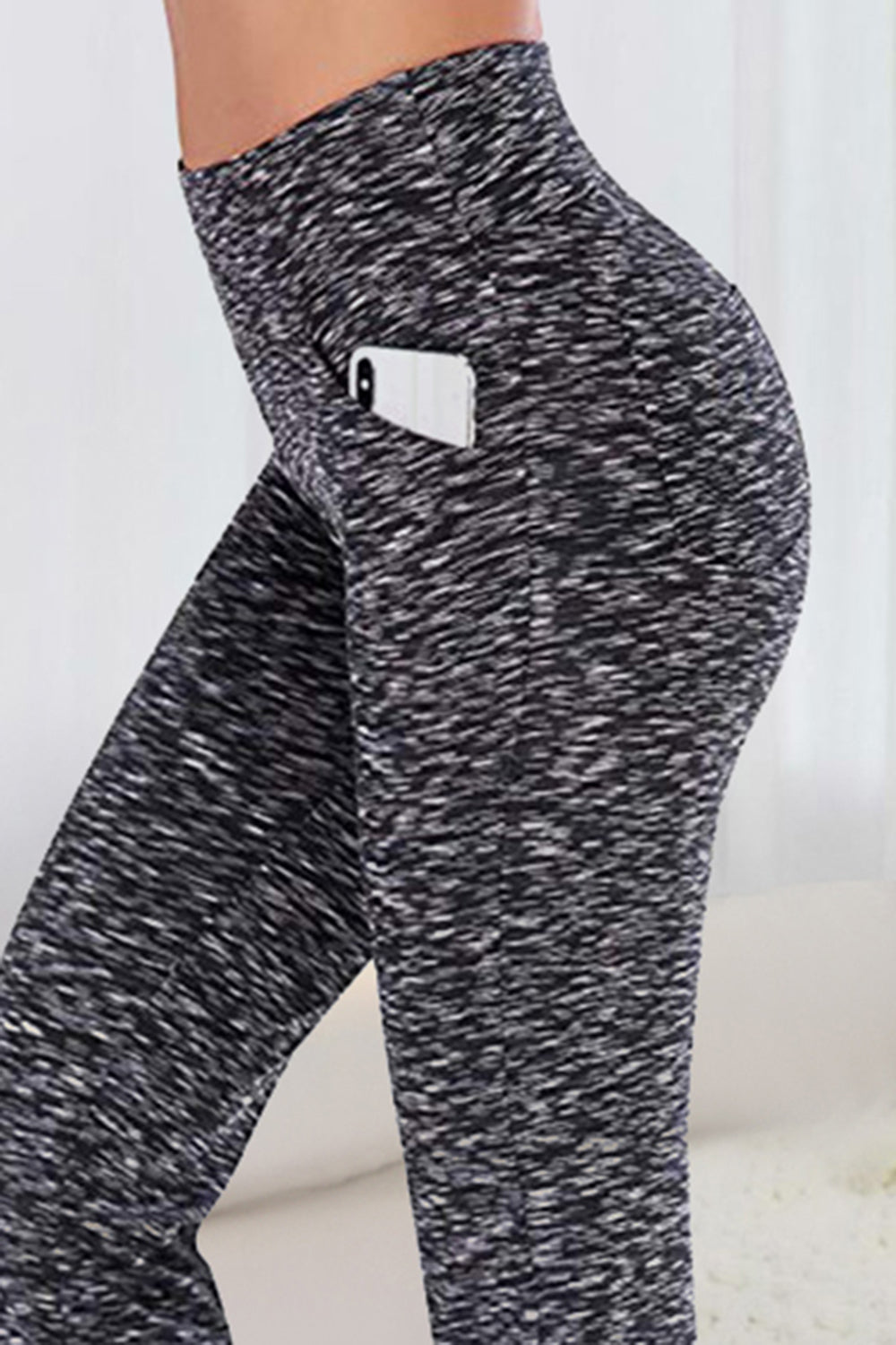 Flare-leg trousers in marled dark gray with side phone pocket and subtle flare.