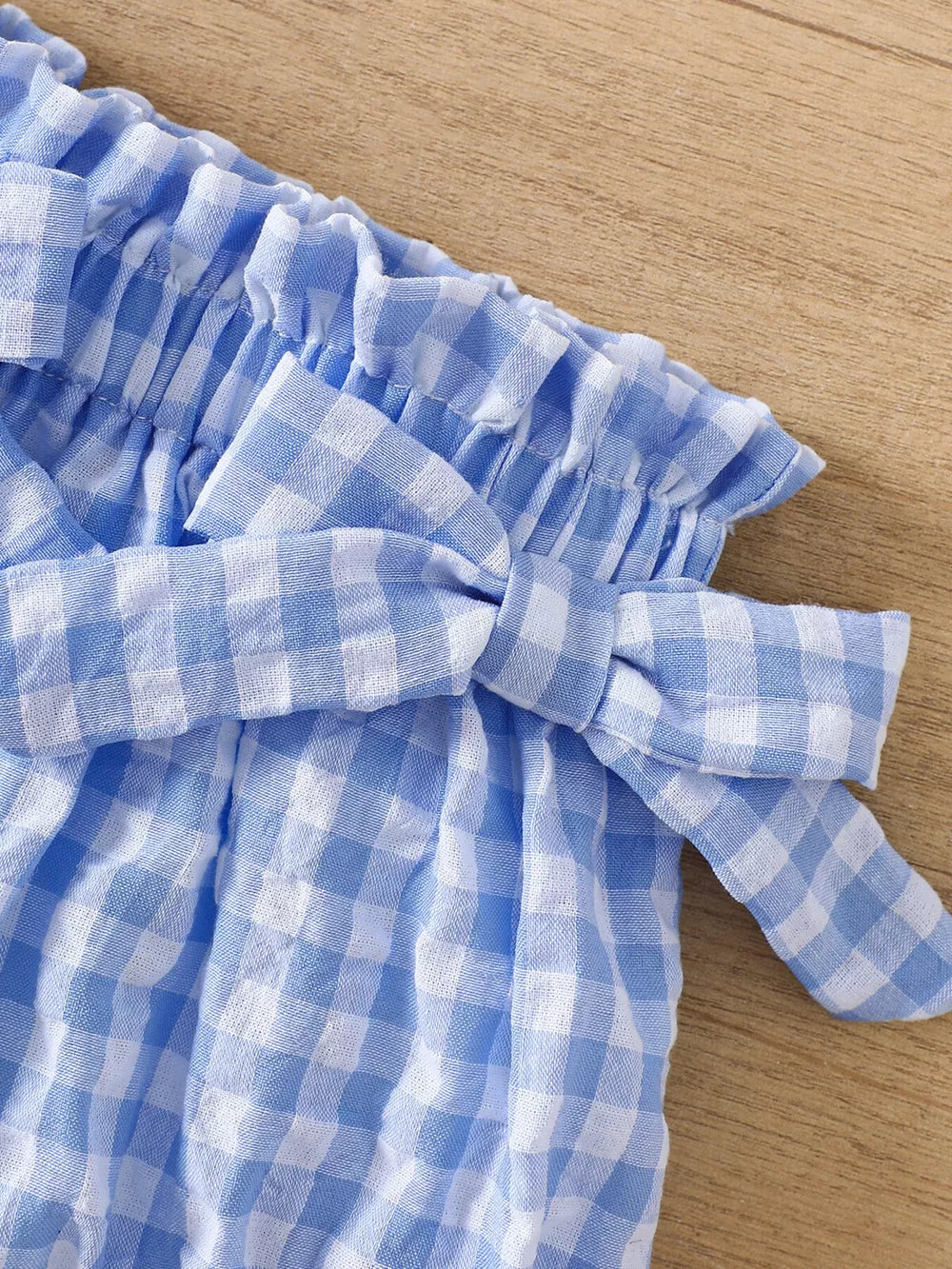 Blue gingham cotton cami and shorts set with ruffle trim and bow detail.
