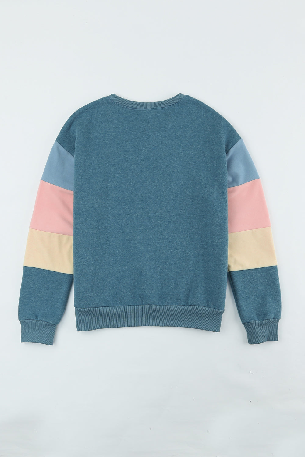 Crewneck sweatshirt with colorblock sleeves in French blue, dusty pink, and cream.