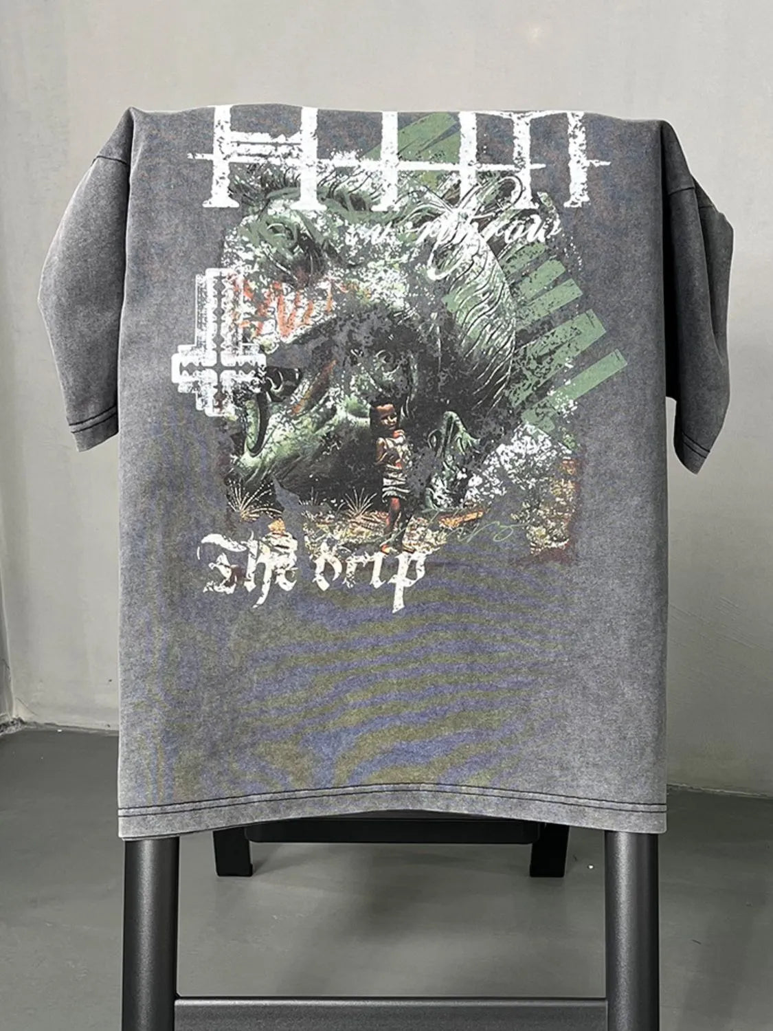 Acid wash graphic t-shirt in dark gray with "The Drip" text and a detailed graphic print.