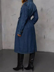 Dark denim trench coat with belted waist and button details.