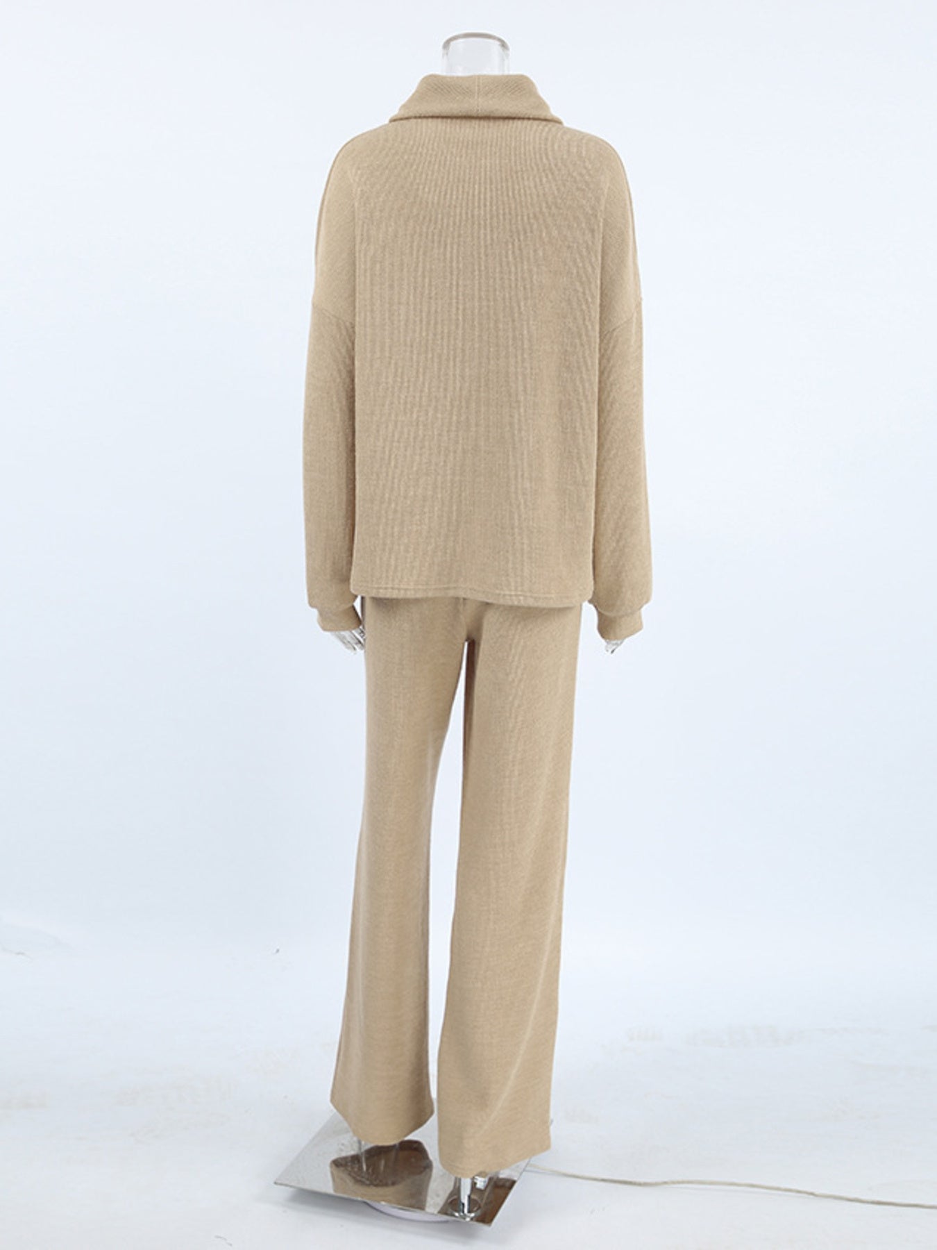 Beige cowl-neck turtleneck and wide-leg pants set with ribbed texture.