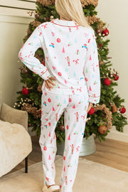 White festive print pajama set with contrast trim and long sleeves.