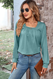 Light green long sleeve top with square neckline and pleated detail