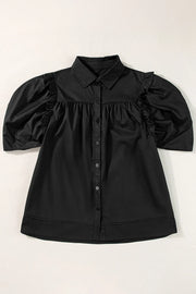 Black poplin blouse with gathered puff sleeves, button front, and ruffled shoulder detail.