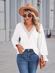White eyelet lace inset blouse with blouson sleeves and ruffled cuffs.