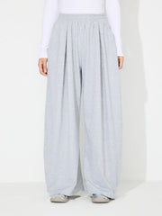 Light gray pleated drape palazzo trousers with elastic waistband.