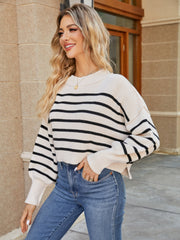 Ivory and black striped cropped knit sweater with balloon sleeves and crew neck.
