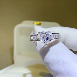 Silver heart-cut moissanite ring with baguette band