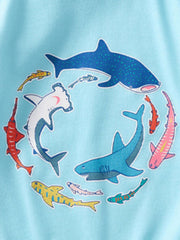 Baby T-shirt in pastel blue cotton with a playful shark and fish print.