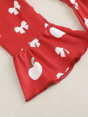 Red cotton bodysuit with white apple and bow print, ruffled bell sleeves.