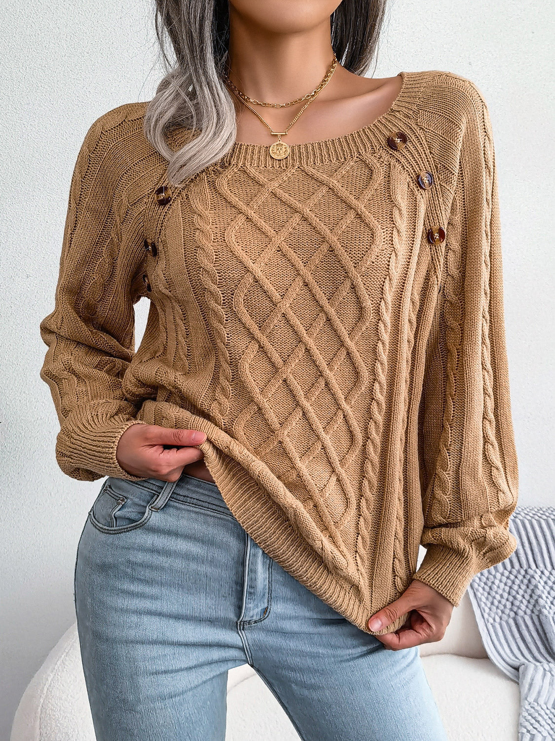 Khaki cable-knit sweater with buttoned shoulder detail and diamond pattern