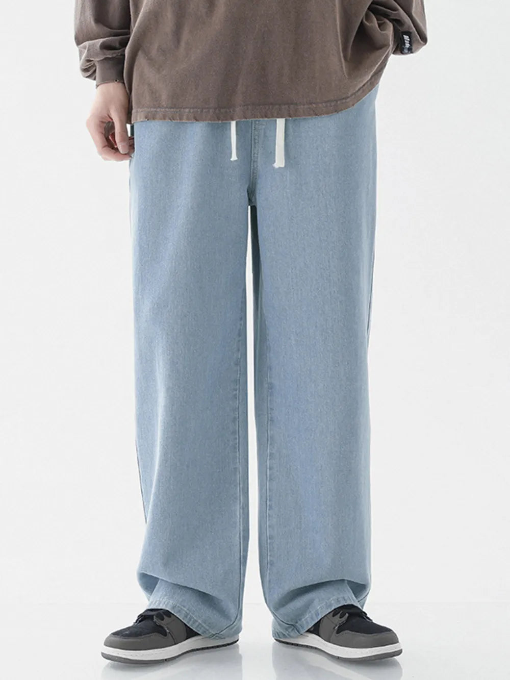 Light blue relaxed wide-leg jeans with white drawstring waist