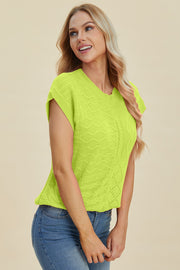 Lime green knit patchwork top with cap sleeves and varied stitch patterns.