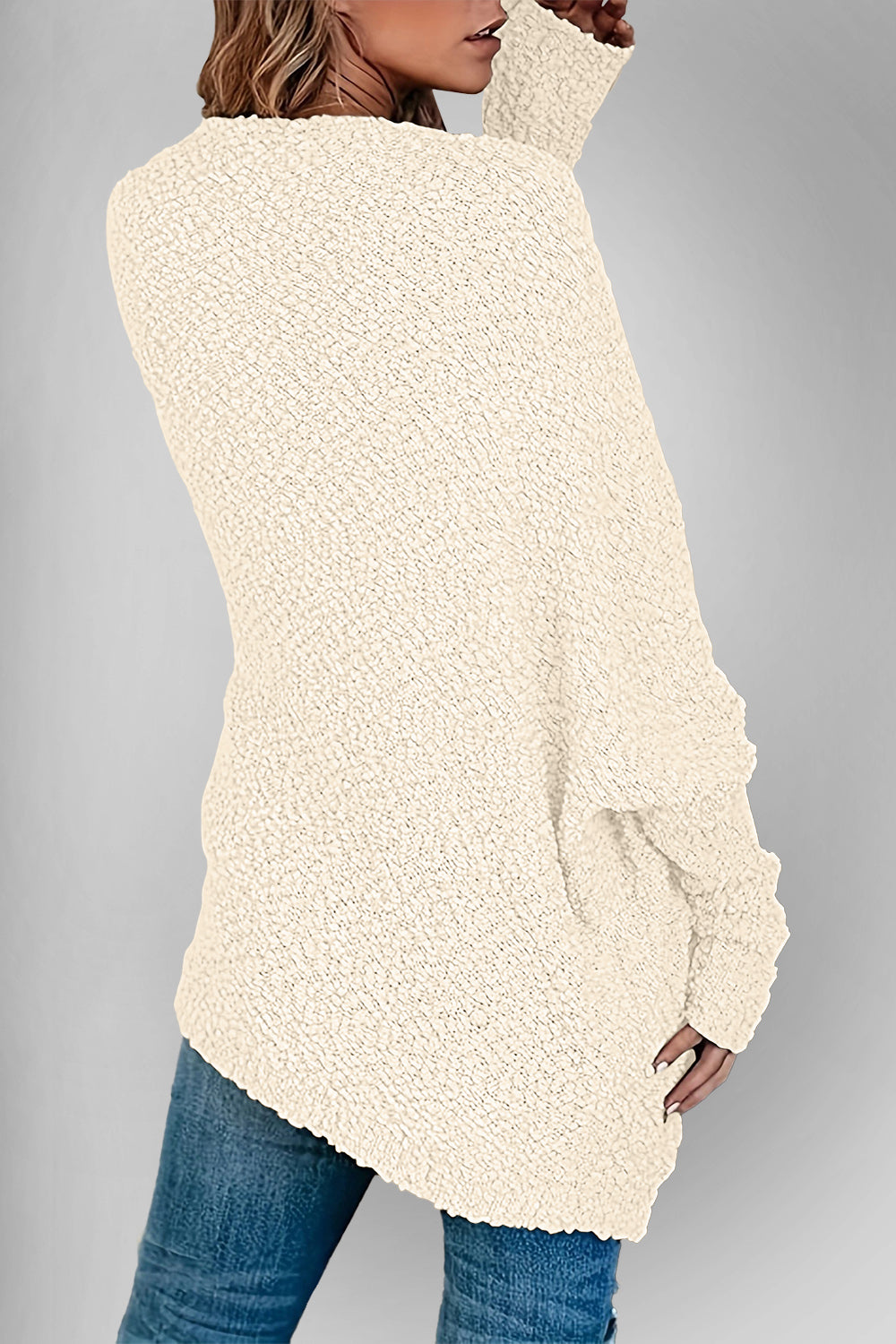 Cream popcorn knit open cardigan with textured fabric and long sleeves.