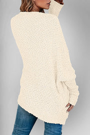 Cream popcorn knit open cardigan with textured fabric and long sleeves.