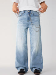 Men's light wash wide-leg jeans with chain detail and faded wash.