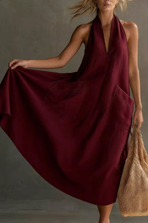 Burgundy halter midi dress with V-neck and two large front pockets.