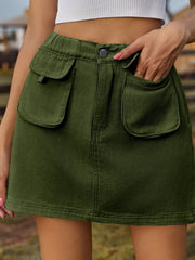 Dark green denim mini skirt with elastic waist and button detail.