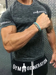 Performance knit gym tee in dark gray with textured pattern and logo detail on sleeve.