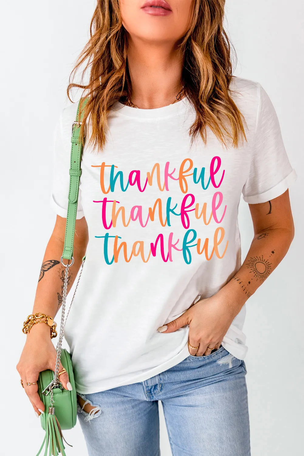 White graphic tee with stacked colorful script "thankful" text