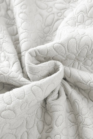 White bomber jacket with subtle embossed floral pattern