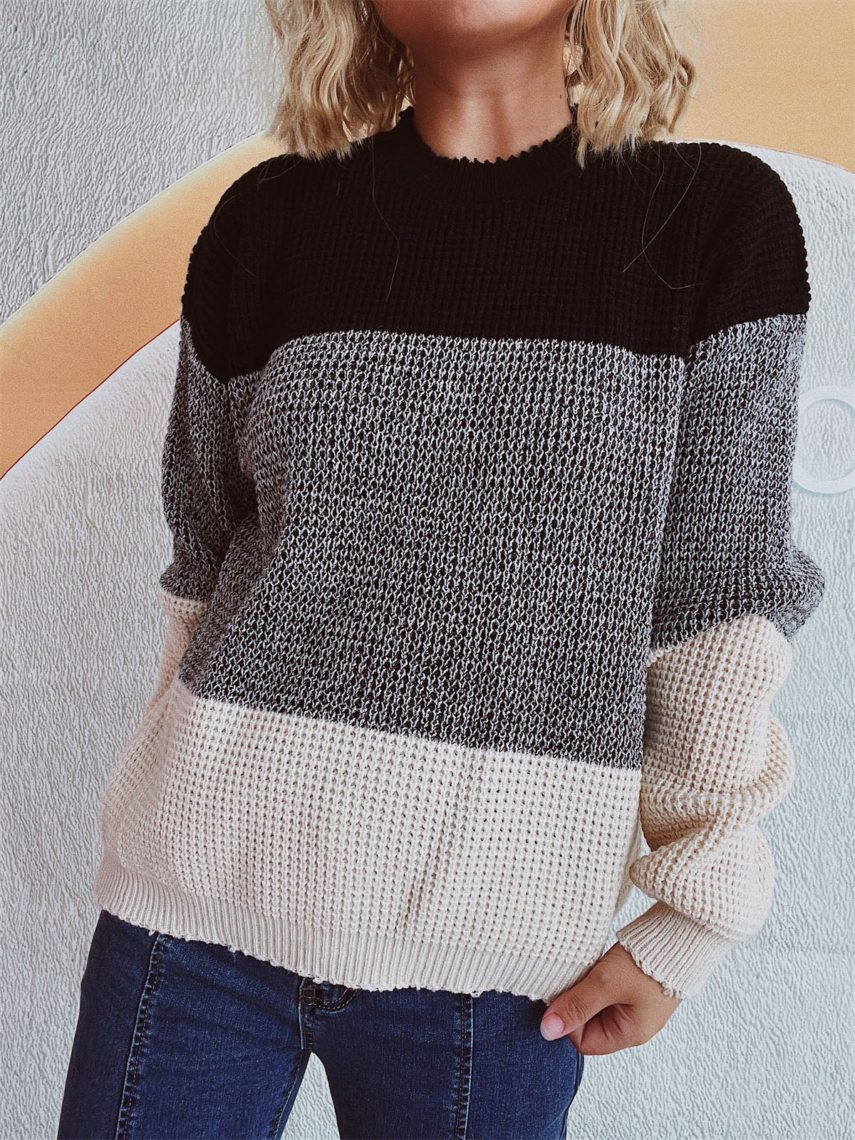 Colorblock textured knit pullover sweater with black, gray, and cream panels.