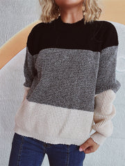 Colorblock textured knit pullover sweater with black, gray, and cream panels.