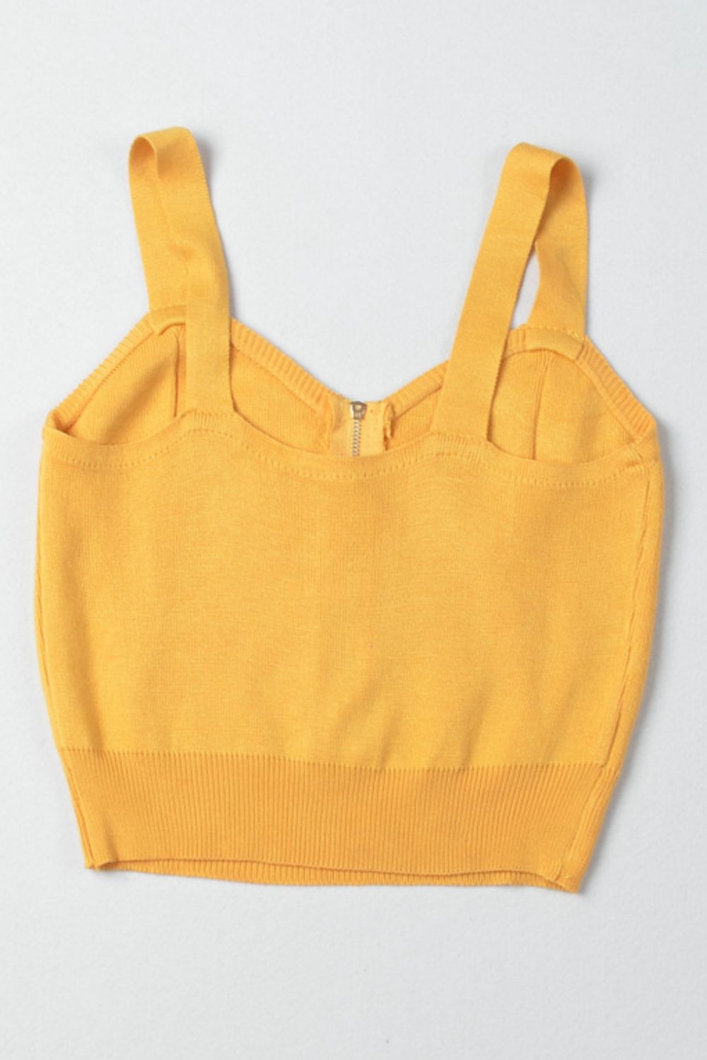 Gold ribbed knit crop top with exposed zipper and wide straps.