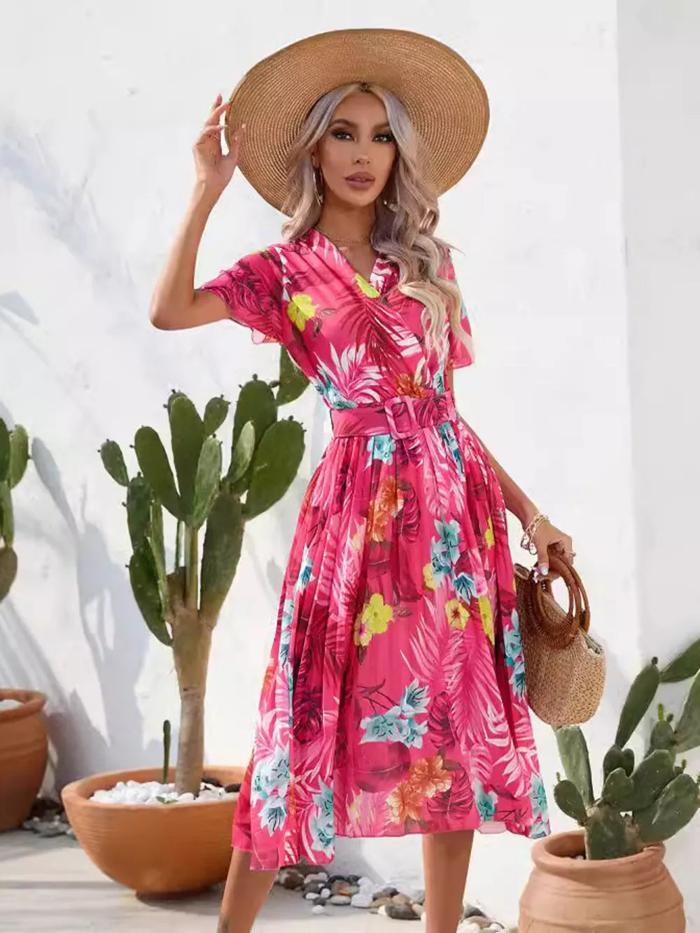 Hot pink tropical pleated midi dress with belt and short sleeves.