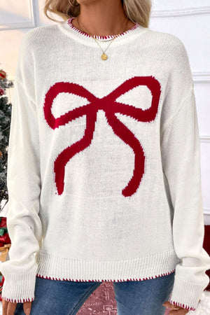 White acrylic knit sweater with a large red bow graphic and contrast stitching.