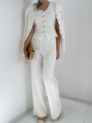 White ribbed knit outfit set with gold buttons, featuring a cardigan, V-neck top, and wide-leg pants.