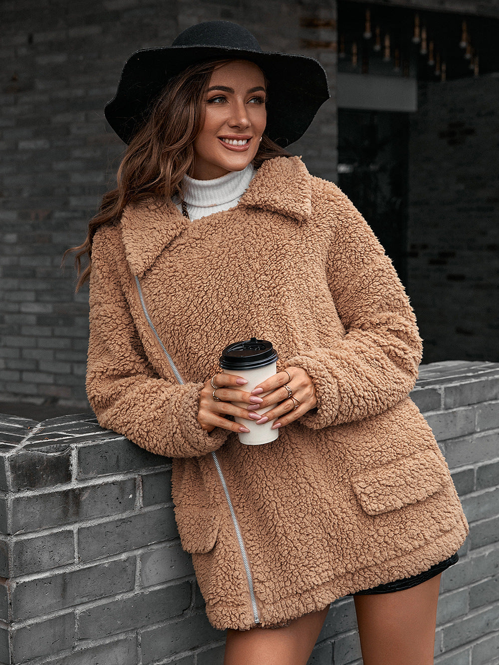 Camel teddy moto jacket with asymmetrical zip and collared neckline.