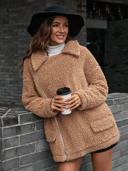 Camel teddy moto jacket with asymmetrical zip and collared neckline.